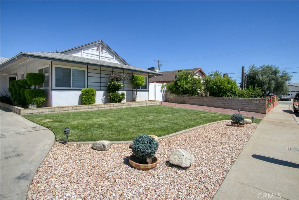 1034 Thompson Avenue Banning, CA 92220 - Photo 22 of 24 a front view of a house with a yard