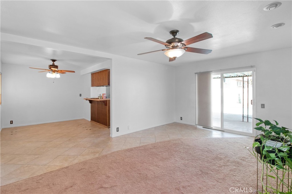 1034 Thompson Avenue Banning, CA 92220 - Photo 6 of 24 a view of a big room with chandelier fan and windows