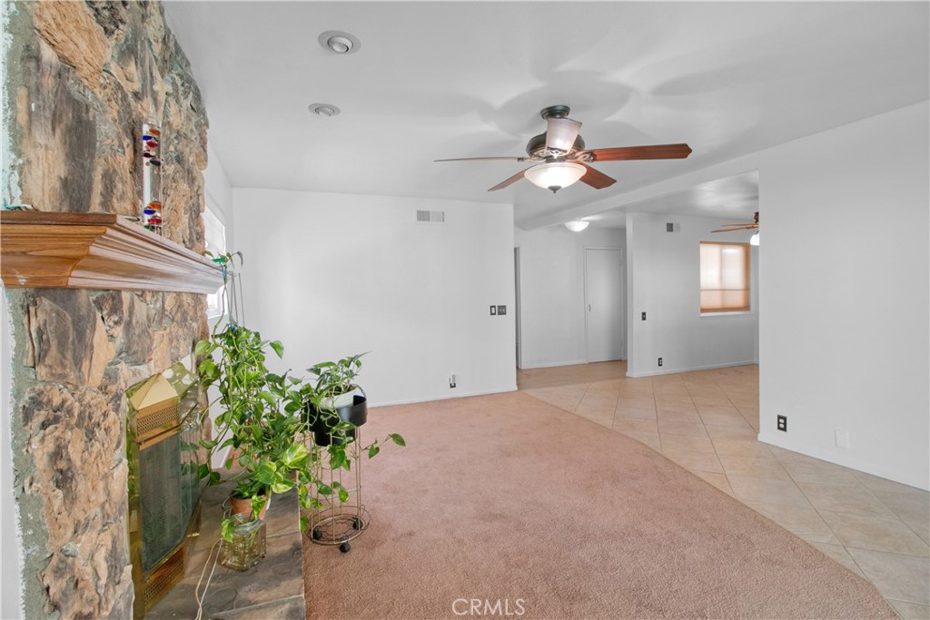 1034 Thompson Avenue Banning, CA 92220 - Photo 8 of 24 a view of a kitchen with a ceiling fan and a chandelier