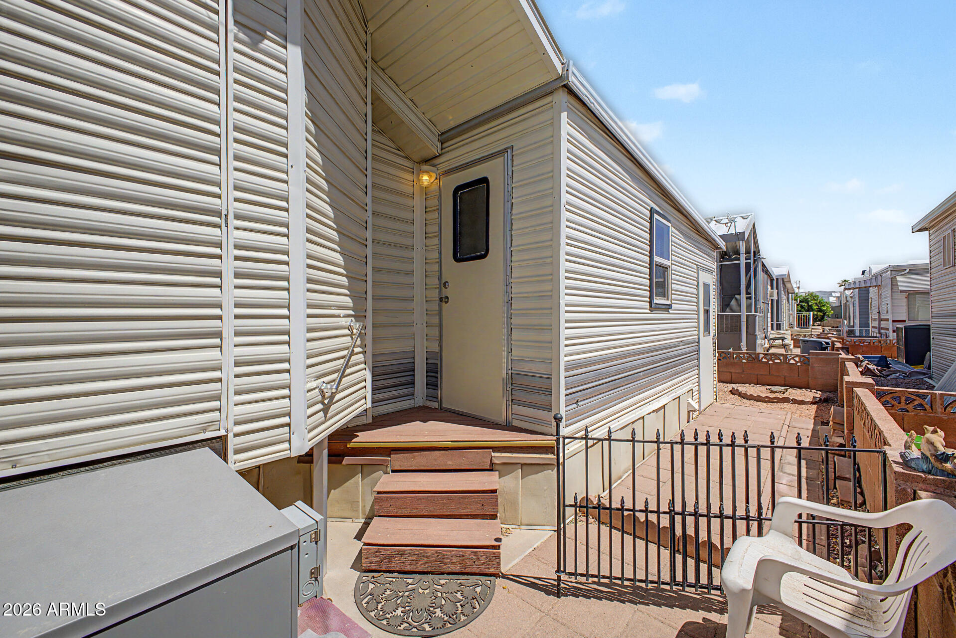 7750 East Broadway Road, Unit 560 Mesa, AZ 85208 - Photo 17 of 18 a view of a patio with a table and chairs