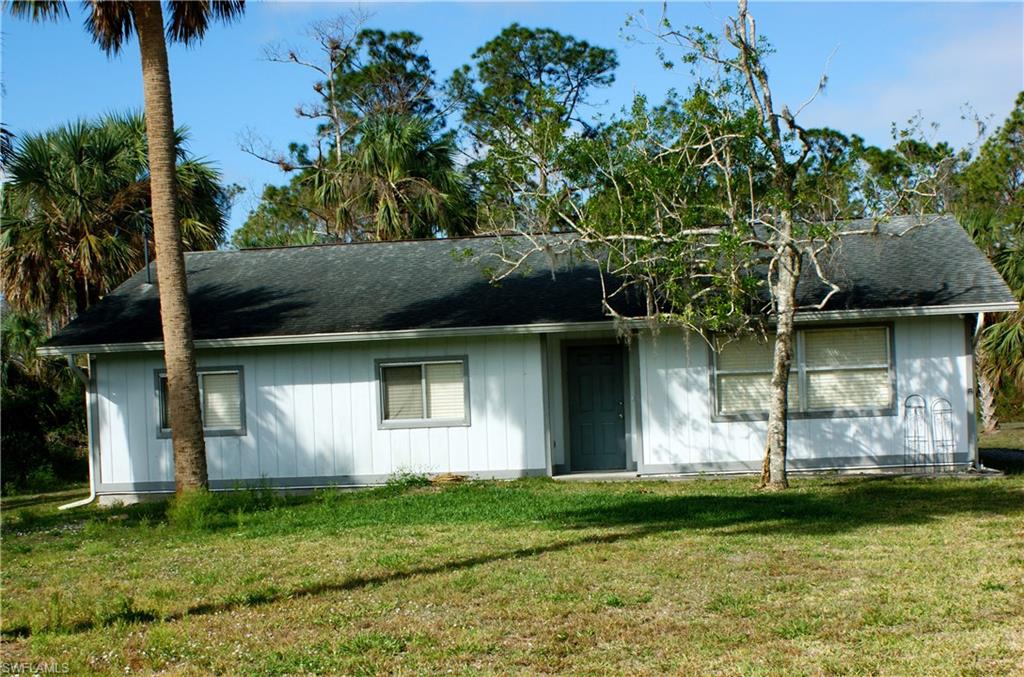 1875 21st Street Southwest Naples, FL 34117 - Photo 1 of 1 a view of a backyard with plants and large trees