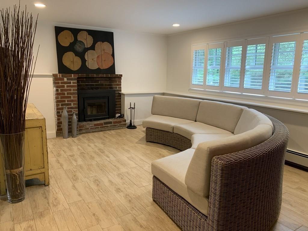 158 Tilden Road Scituate, MA 02066 - Photo 16 of 33 a living room with furniture and a fireplace