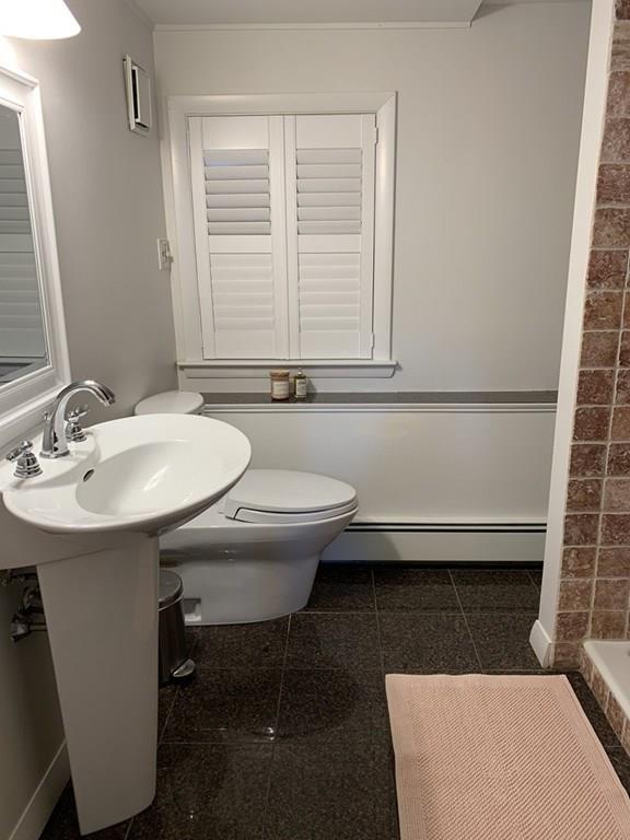 158 Tilden Road Scituate, MA 02066 - Photo 28 of 33 a bathroom with a sink a toilet and mirror