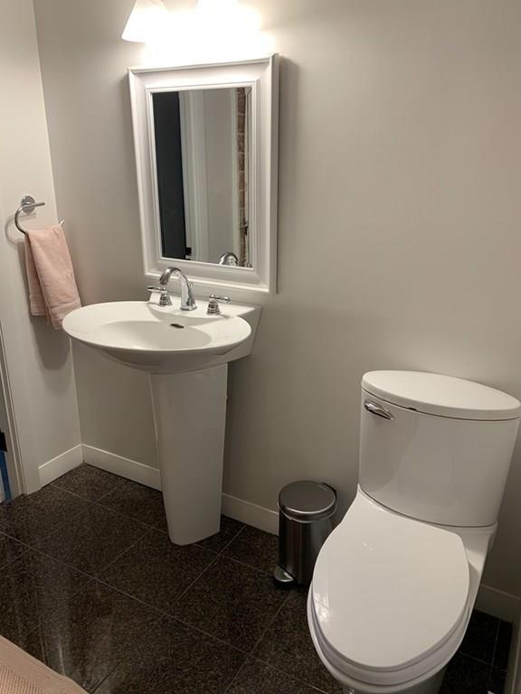 158 Tilden Road Scituate, MA 02066 - Photo 30 of 33 a white toilet sitting next to a bathroom sink
