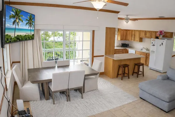 a kitchen with granite countertop a sink cabinets stainless steel appliances and a window