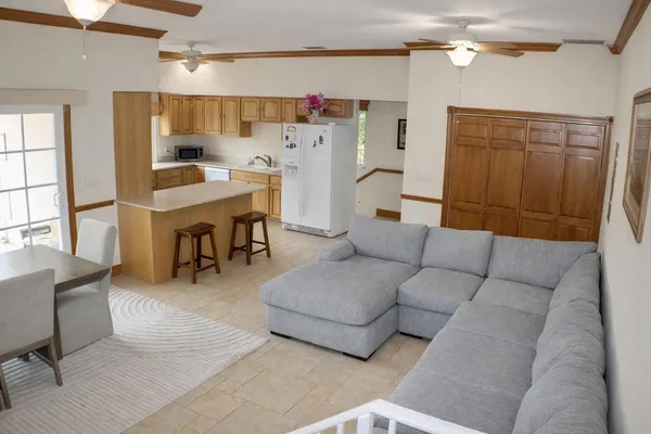 a living room with furniture a flat screen tv and a table