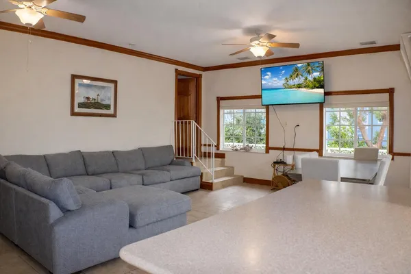 a view of a balcony with chairs and wooden fence