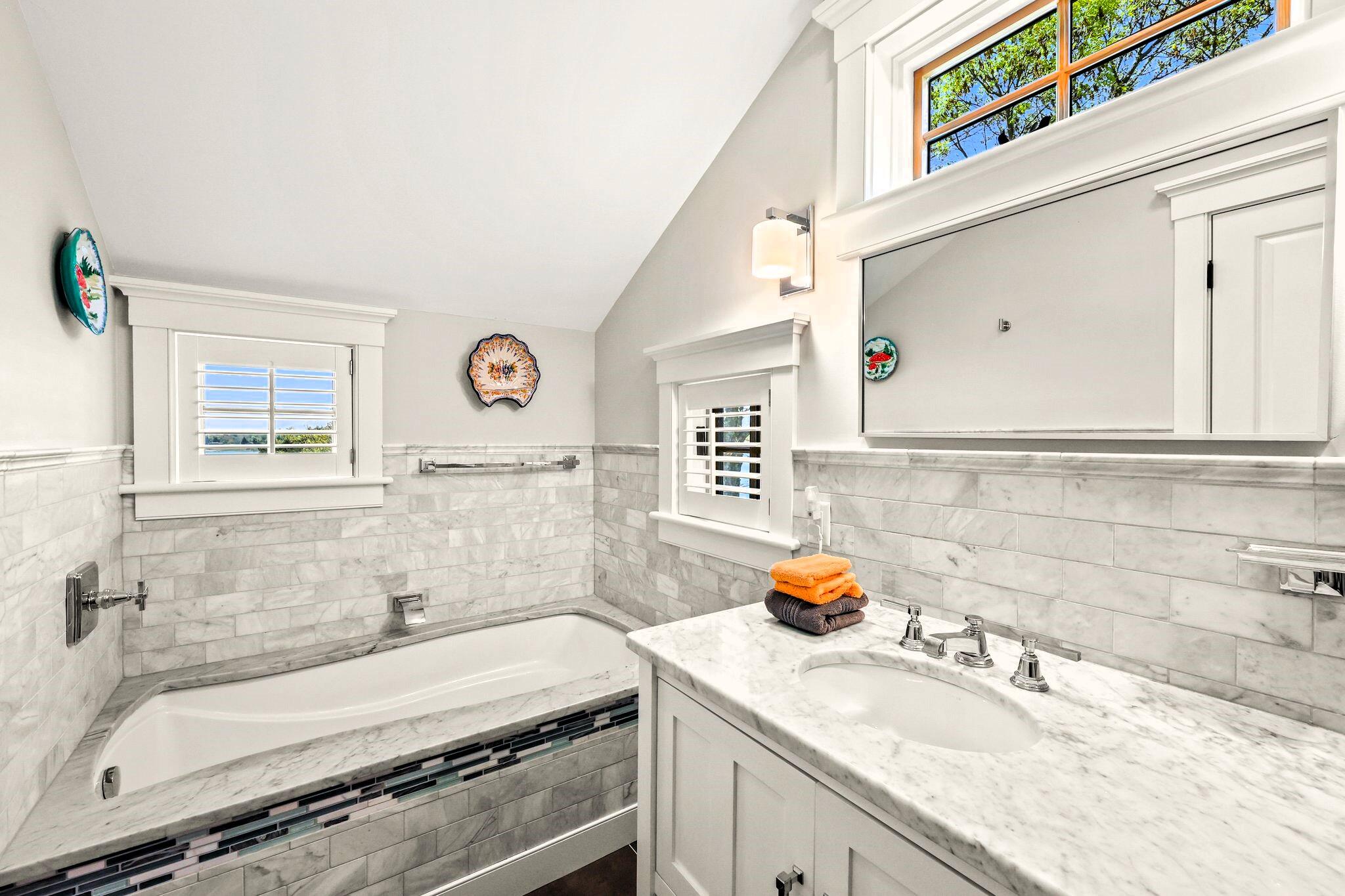 40 Gibson Road Orleans, MA 02653 - Photo 42 of 69 a bathroom with a granite countertop sink and a mirror