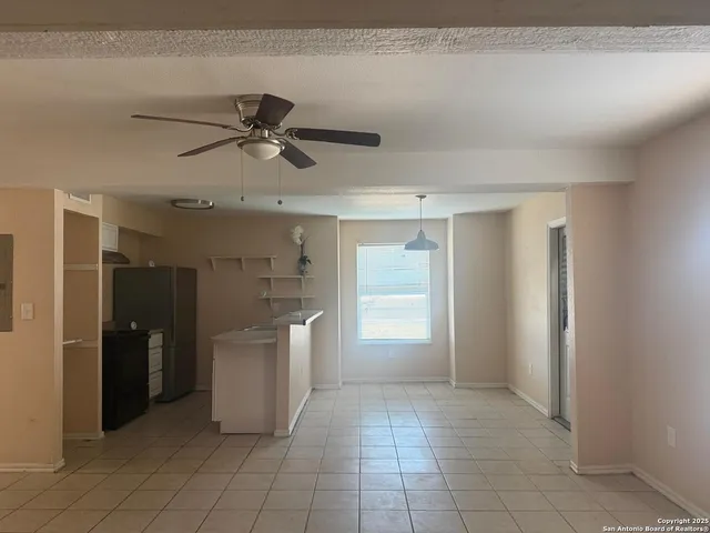 a view of a kitchen with a sink and a refrigerator