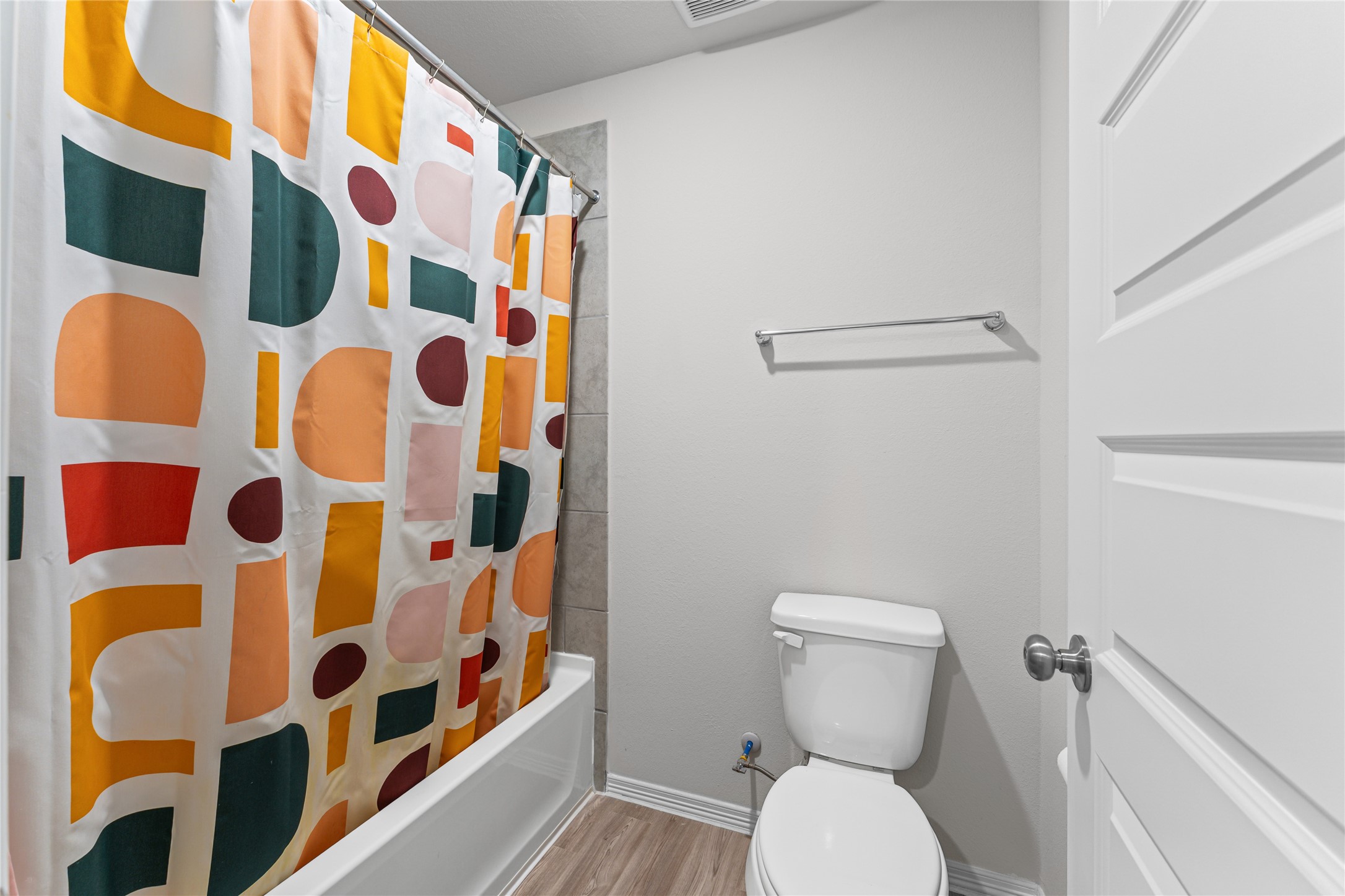 23326 Spring Genesis Lane Katy, TX 77493 - Photo 26 of 32 a white toilet sitting next to a shower curtain