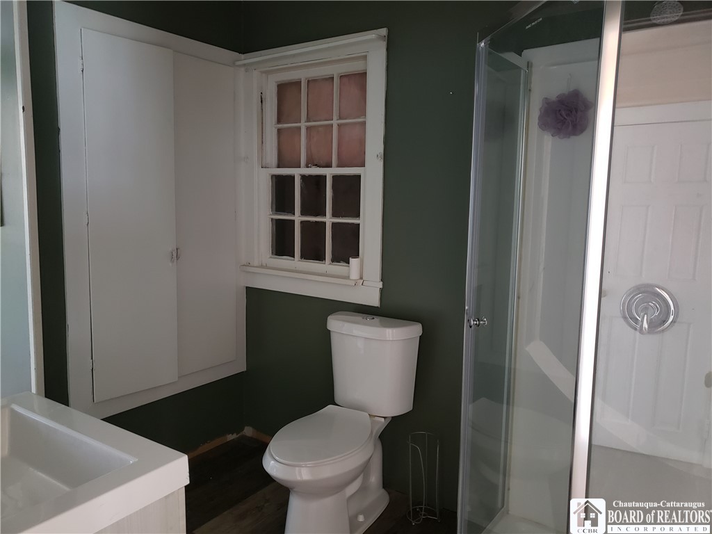 49 Berry Road Pomfret, NY 14063 - Photo 8 of 10 downstairs bathroom with walk-in shower and glass