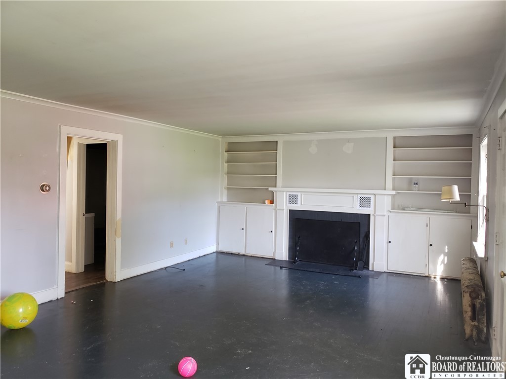 49 Berry Road Pomfret, NY 14063 - Photo 9 of 10 living room with wood fireplace and built ins.