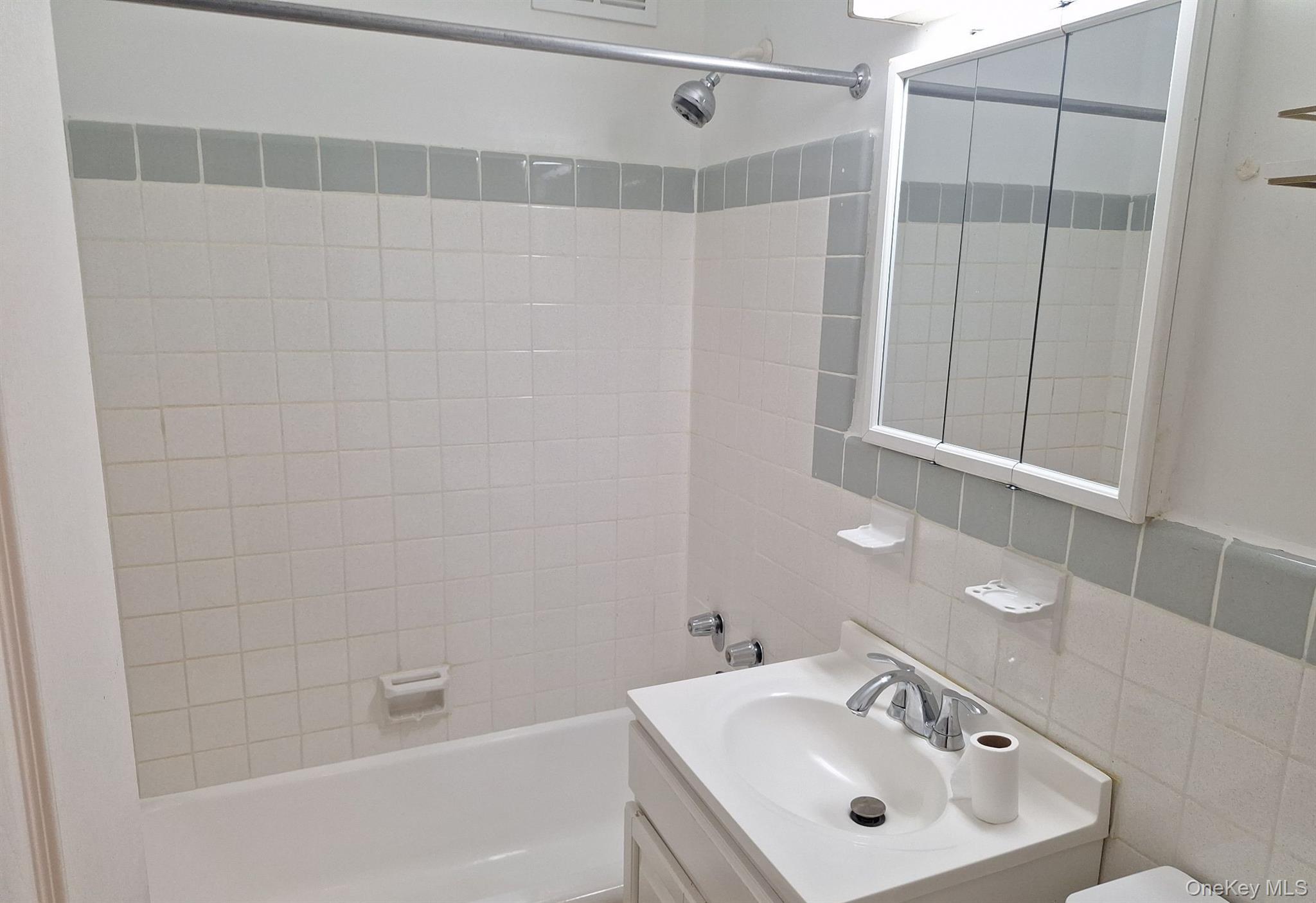 825 Morrison Avenue, Unit 12F Bronx, NY 10473 - Photo 12 of 15 a bathroom with a sink and shower