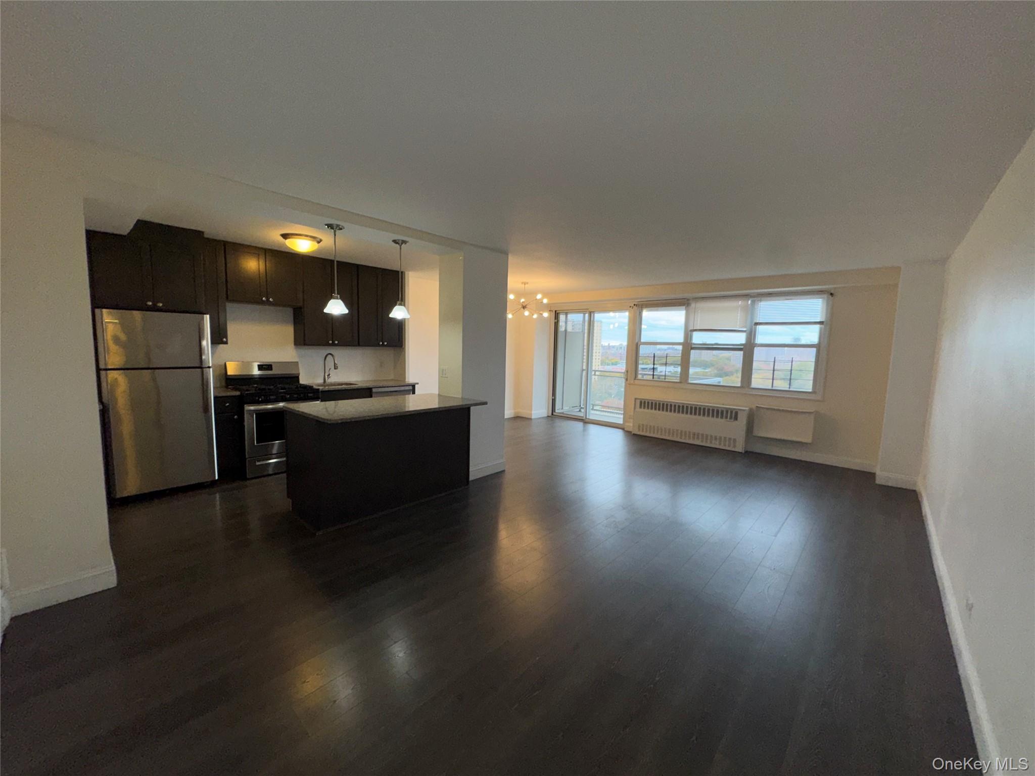 825 Morrison Avenue, Unit 12F Bronx, NY 10473 - Photo 6 of 15 an open kitchen with a sink and dishwasher a oven with wooden floor