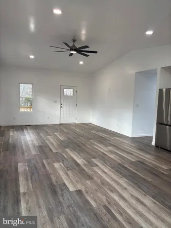 a kitchen with stainless steel appliances a refrigerator and a stove top oven