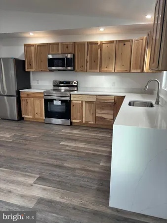 a kitchen with stainless steel appliances granite countertop white cabinets a sink and dishwasher