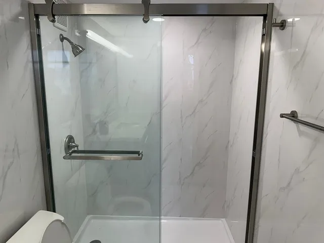 a bathroom with a shower and a toilet