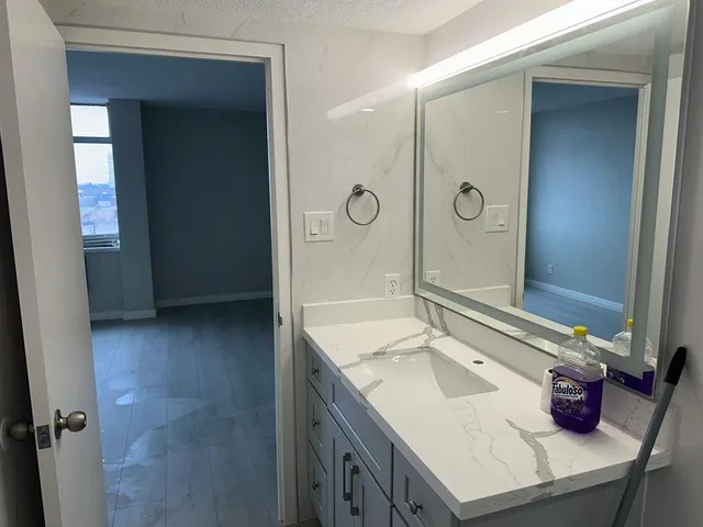 a bathroom with a sink and a mirror