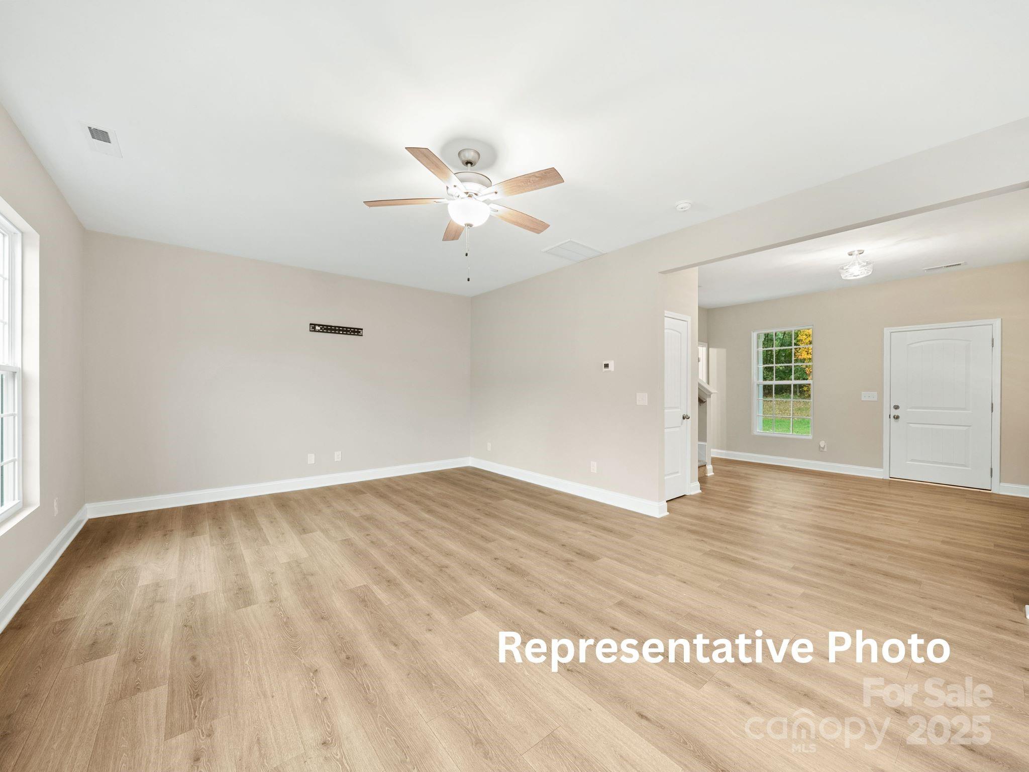 816 North Rocky River Road, Unit 7 Monroe, NC 28110 - Photo 3 of 6 wooden floor in an empty room with a window