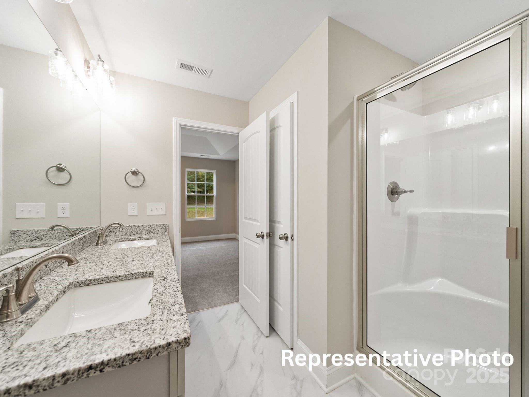 816 North Rocky River Road, Unit 7 Monroe, NC 28110 - Photo 5 of 6 a en suite bathroom with a granite countertop tub sink and shower