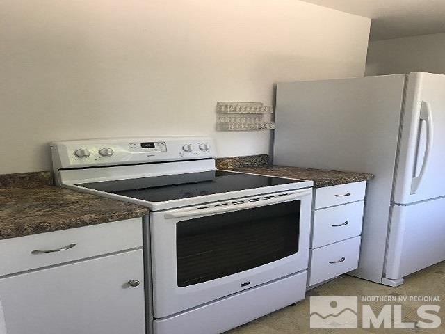 1981 Wilder Street Reno, NV 89512 - Photo 12 of 25 a white stove top oven sitting inside of a kitchen