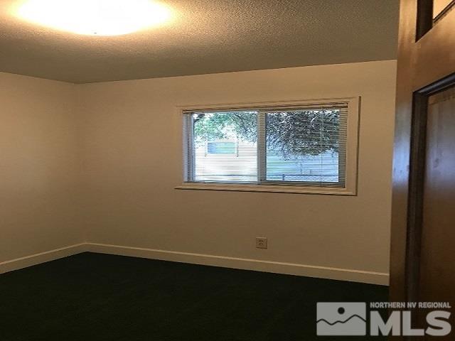 1981 Wilder Street Reno, NV 89512 - Photo 9 of 25 a view of an empty room with wooden floor and a window