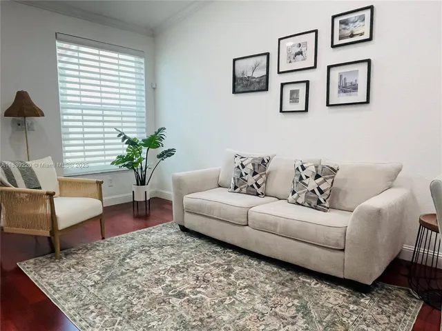 a living room with furniture and a potted plant