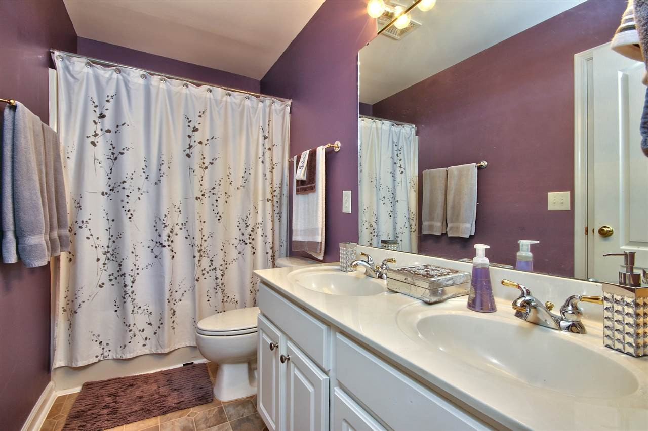 7616 Derek Drive Raleigh, NC 27613 - Photo 21 of 25 Full bath with double vanity and tub/shower combo. Located on 2nd floor and 1/2 bath on 1st. Bathroom