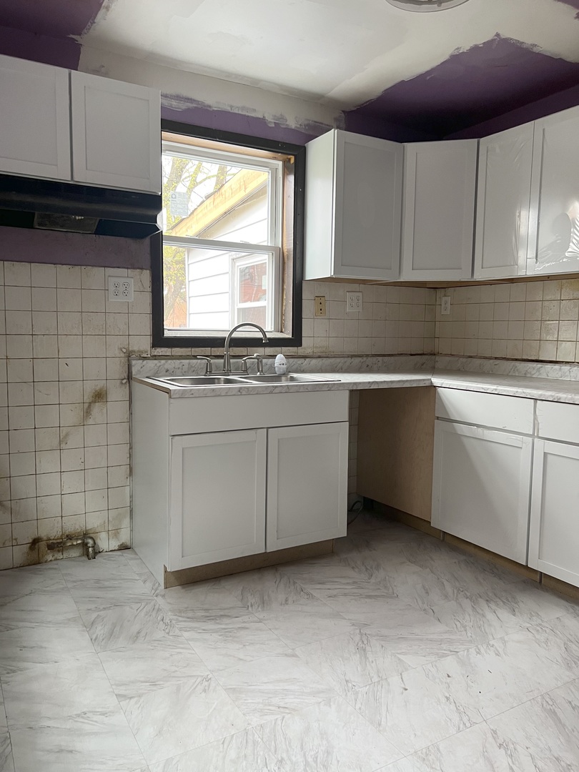Undisclosed Address Chicago, IL 60620 - Photo 7 of 18 a kitchen with stainless steel appliances granite countertop a sink and cabinets