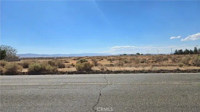 a view of a field with an ocean view