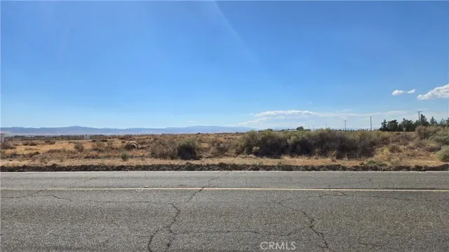a view of a field with mountain in the back