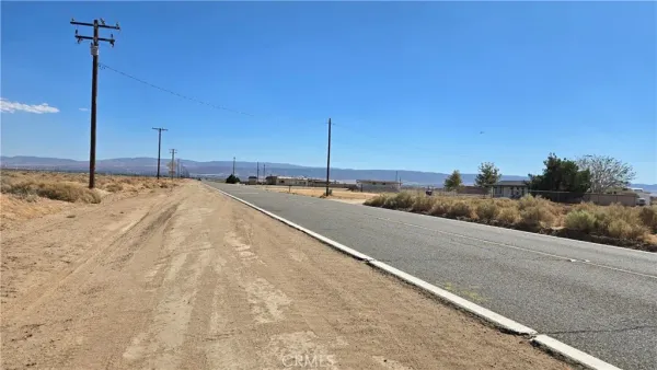 a view of a road with a building in the background
