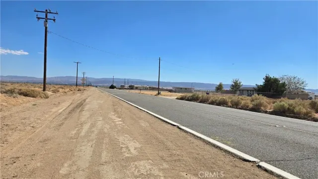 a view of a road with a building in the background