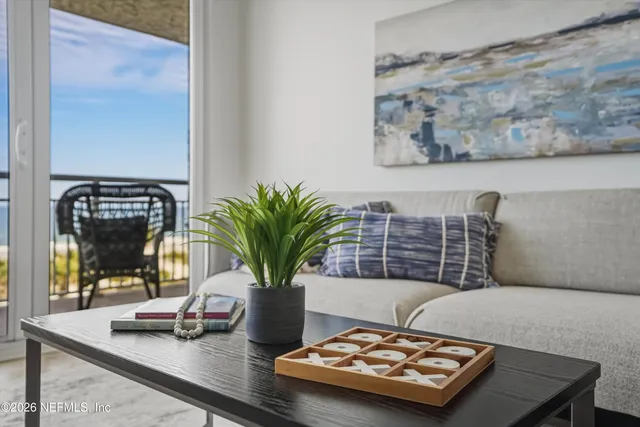 a living room with furniture and potted plant