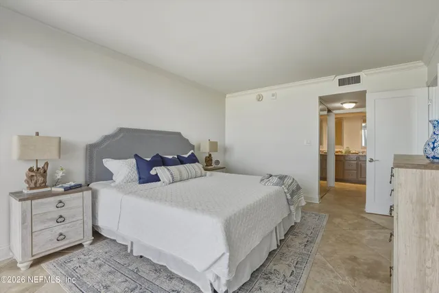 a large white bed in a white room