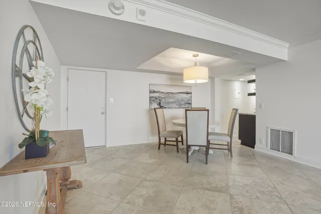 a view of a dining room with furniture and a chandelier
