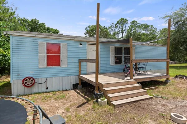 a view of backyard with patio
