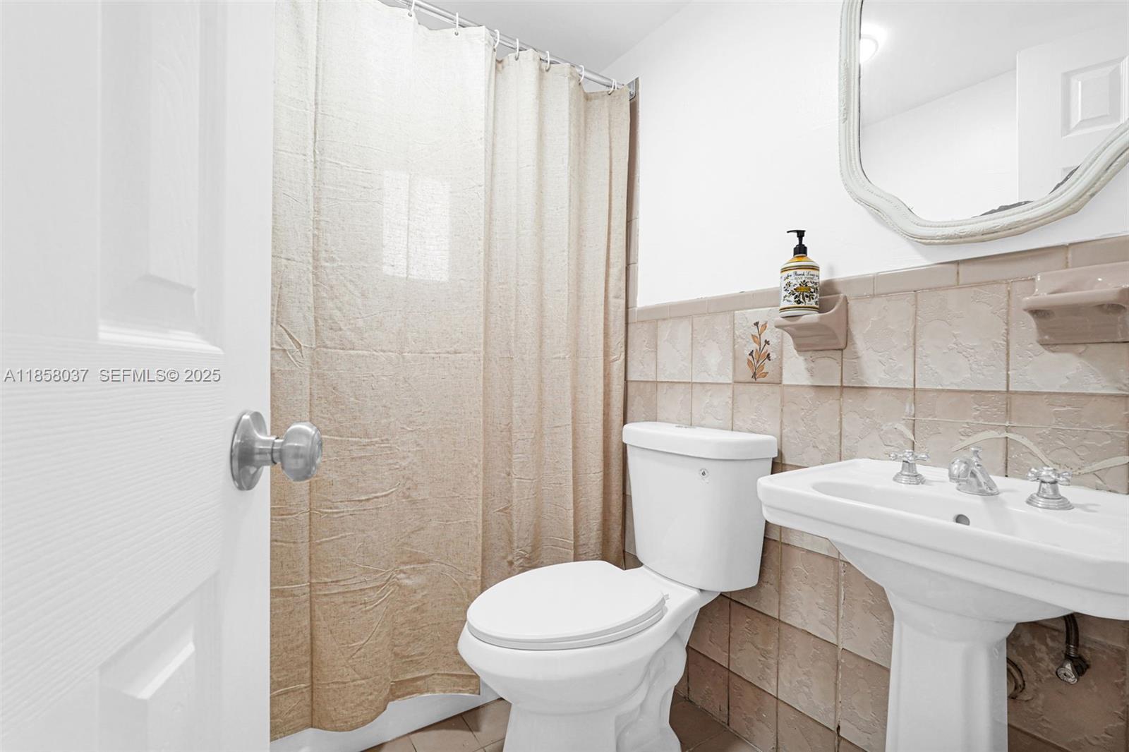 3711 Southwest 87th Avenue Miami, FL 33165 - Photo 12 of 92 a bathroom with a sink toilet and a mirror