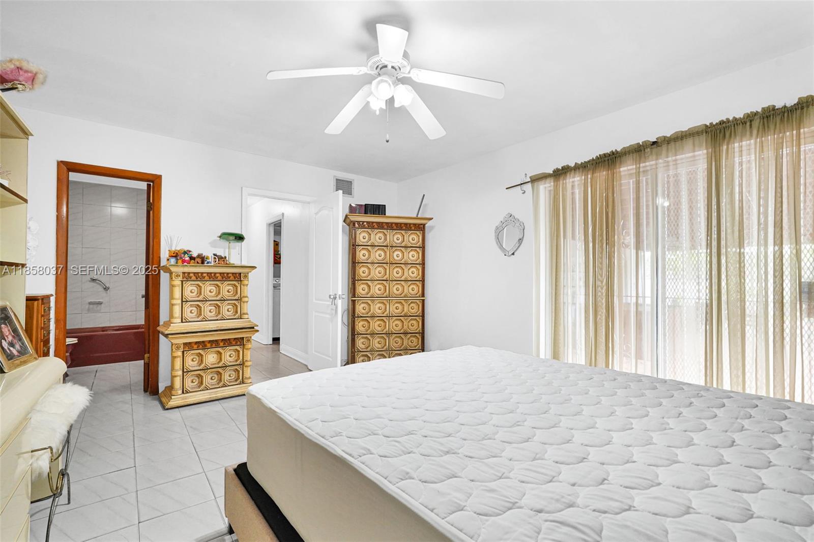 3711 Southwest 87th Avenue Miami, FL 33165 - Photo 27 of 92 a bedroom with a bed and dresser with mirror