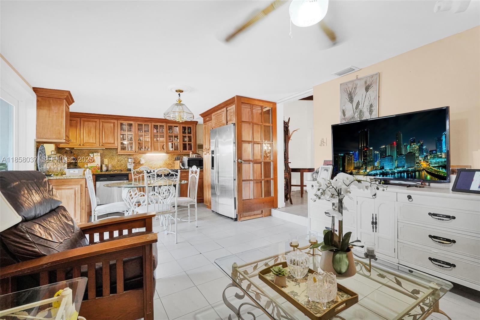 3711 Southwest 87th Avenue Miami, FL 33165 - Photo 33 of 92 a living room with furniture a flat screen tv and kitchen view
