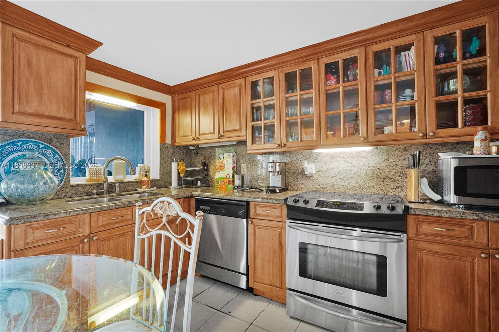 3711 Southwest 87th Avenue Miami, FL 33165 - Photo 37 of 92 a kitchen with stainless steel appliances granite countertop a stove top oven a sink dishwasher and cabinets with wooden floor