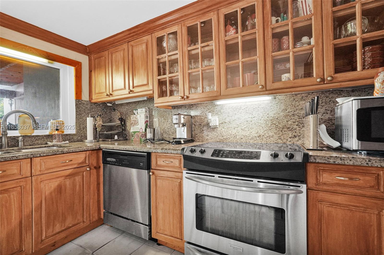 3711 Southwest 87th Avenue Miami, FL 33165 - Photo 38 of 92 a kitchen with stainless steel appliances granite countertop a stove and a sink