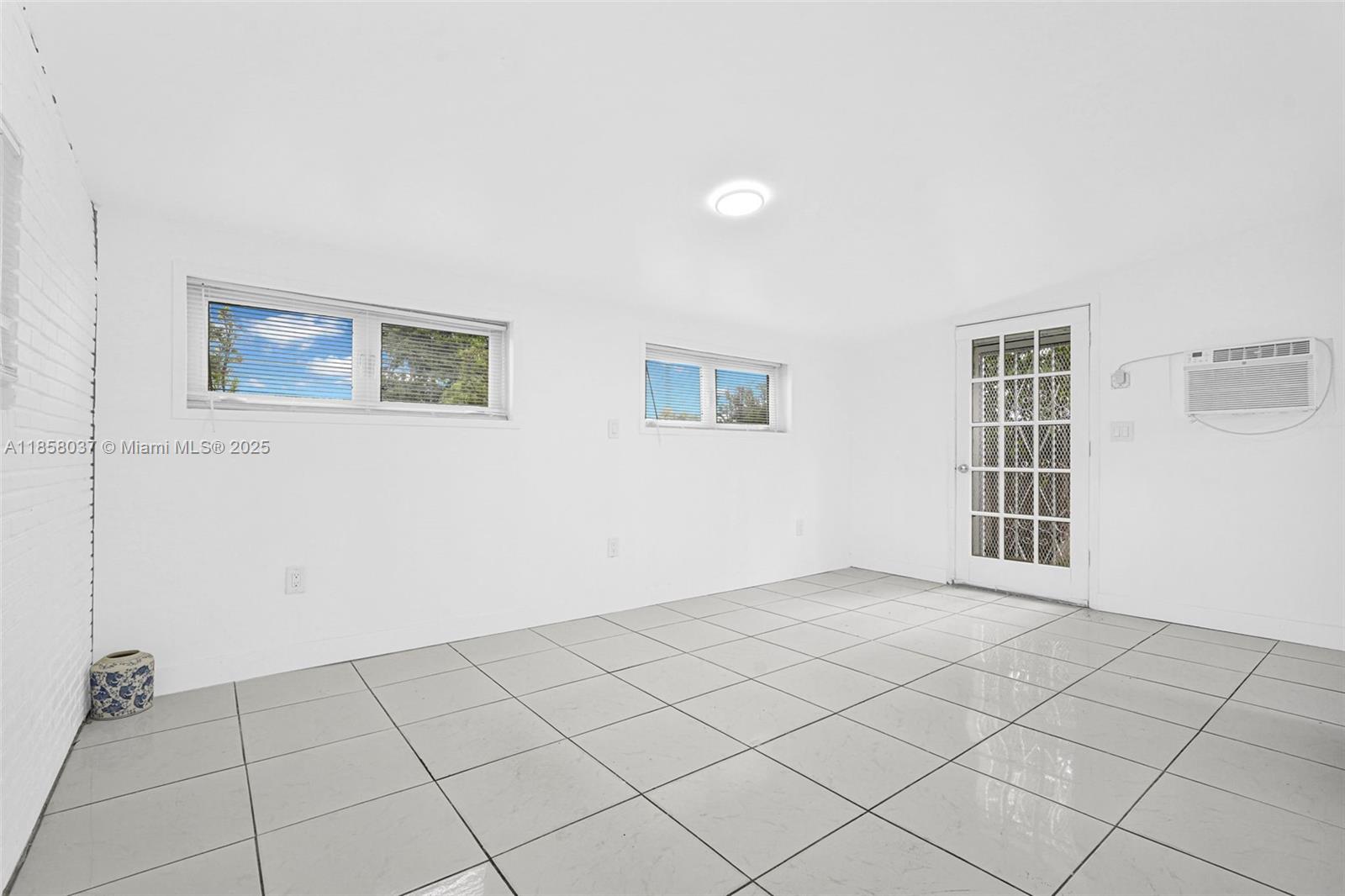 3711 Southwest 87th Avenue Miami, FL 33165 - Photo 4 of 92 a view of an empty room with a window