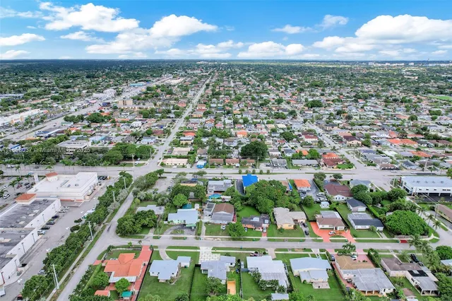 an aerial view of multiple houses with a yard