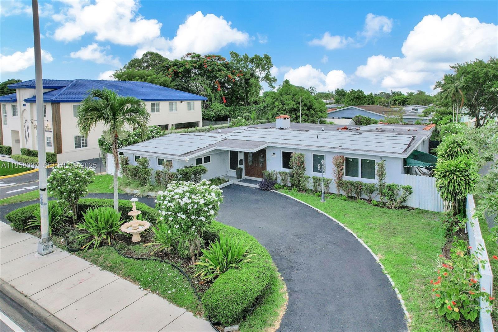 3711 Southwest 87th Avenue Miami, FL 33165 - Photo 60 of 92 a view of a white house with a yard and potted plants