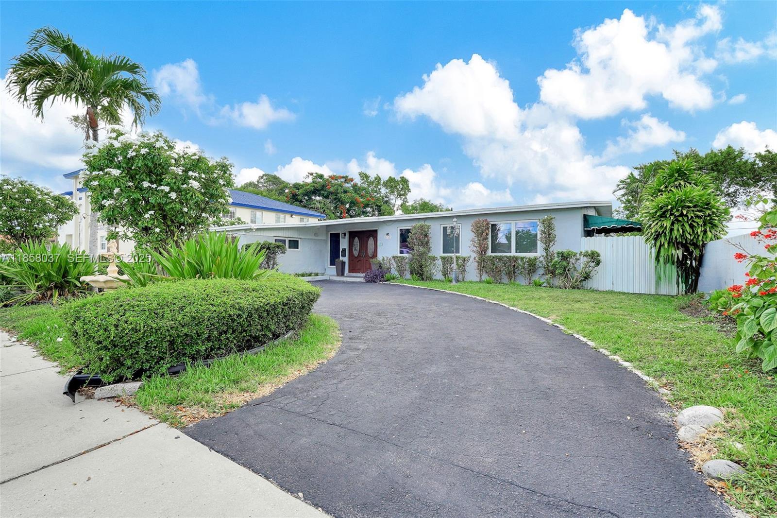 3711 Southwest 87th Avenue Miami, FL 33165 - Photo 64 of 92 a view of house in front of a big yard with potted plants