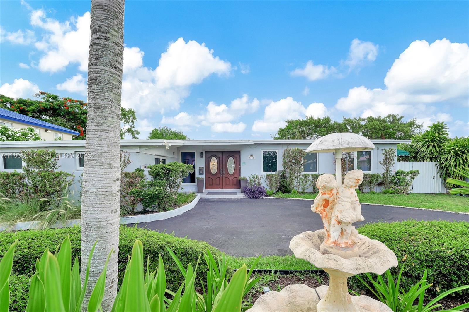 3711 Southwest 87th Avenue Miami, FL 33165 - Photo 65 of 92 a front view of a house with a yard table and chairs