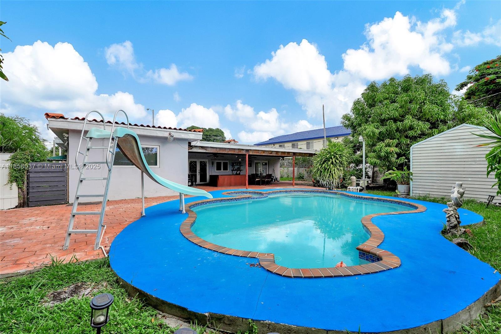 3711 Southwest 87th Avenue Miami, FL 33165 - Photo 68 of 92 a view of a swimming pool with an outdoor seating
