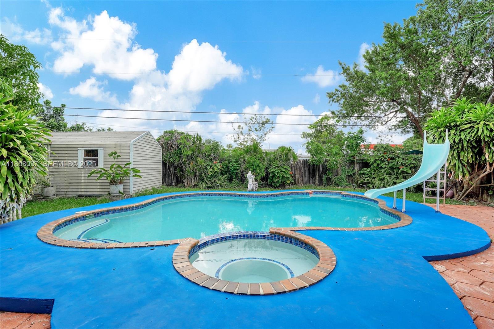 3711 Southwest 87th Avenue Miami, FL 33165 - Photo 73 of 92 a view of a swimming pool with an outdoor space and seating area