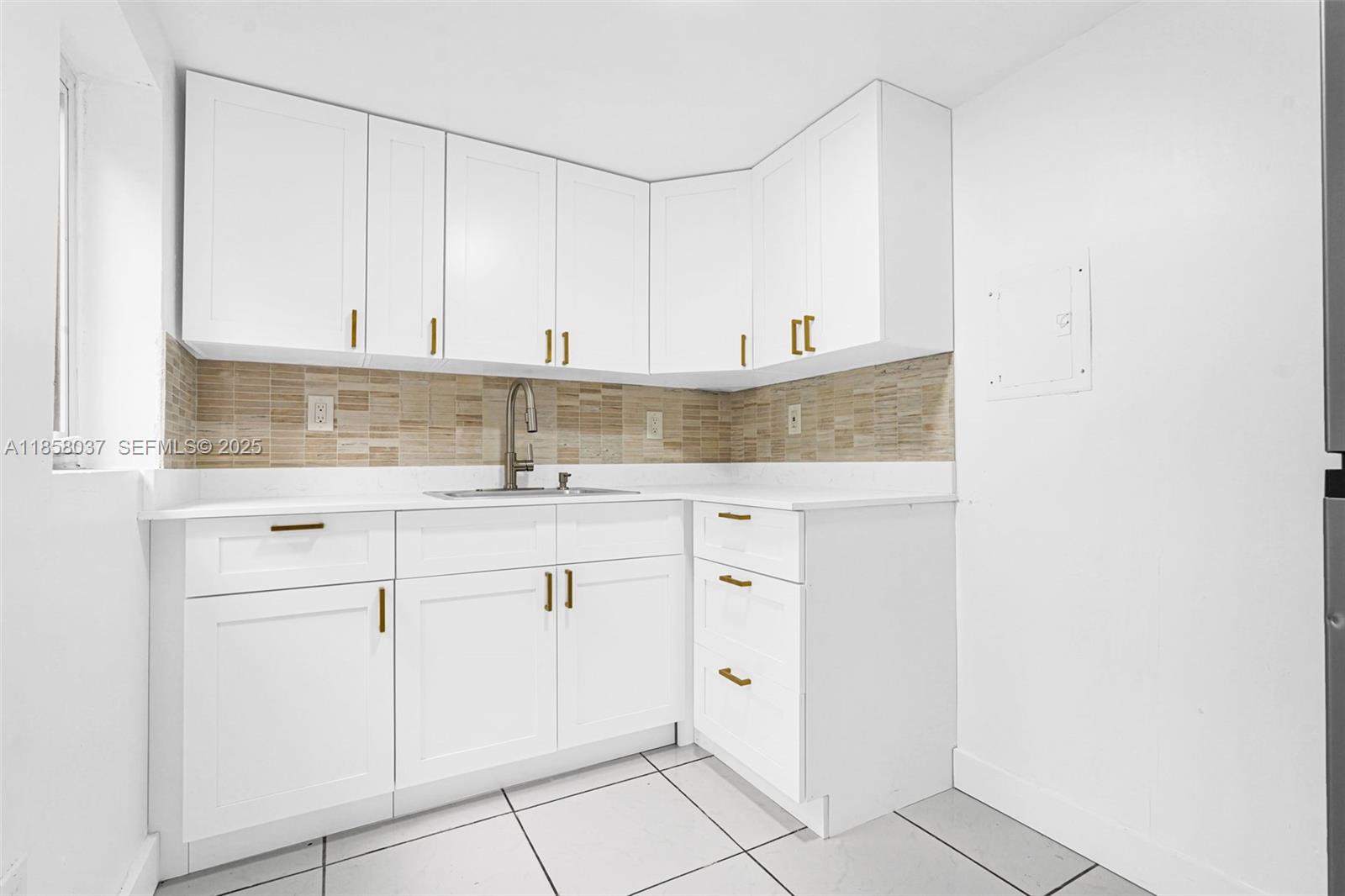 3711 Southwest 87th Avenue Miami, FL 33165 - Photo 8 of 92 a kitchen with granite countertop white cabinets and sink